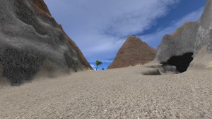 Gravel and mountains with a palm tree in the distance